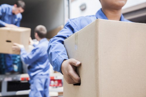 Professional packers organizing household boxes in a local home move