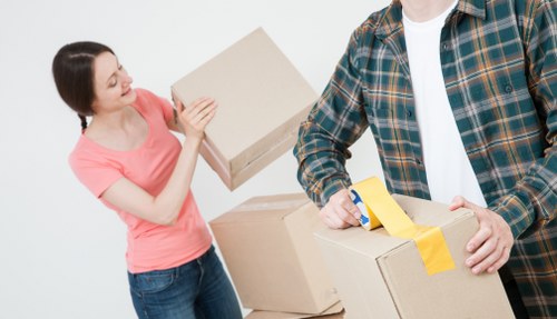 Local movers loading furniture and boxes into a van