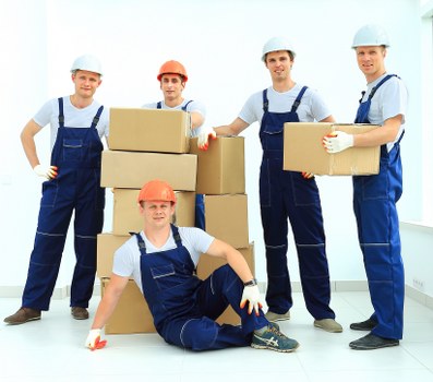 Local moving team preparing fragile and bulky items for transit