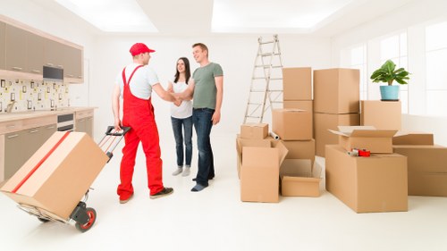 Man with van movers assisting with office and furniture transport