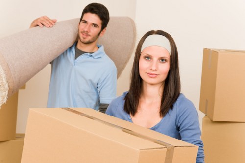 Movers preparing furniture for safe loading into a truck