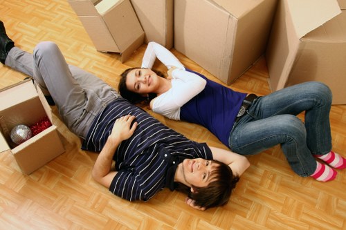 Moving team handling boxes and furniture in a local property
