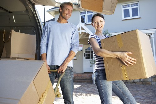 Furniture pick-up team loading bulky items into a moving vehicle